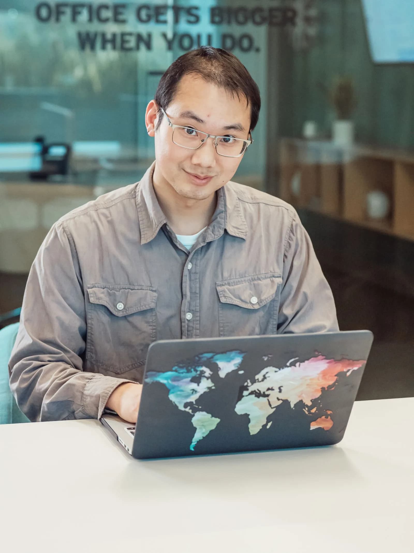 A person working on a laptop in a modern office